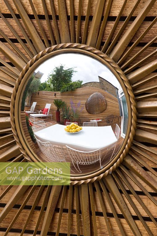 French sixties sunburst mirror on wall. Ben De Lisi House and Garden, London