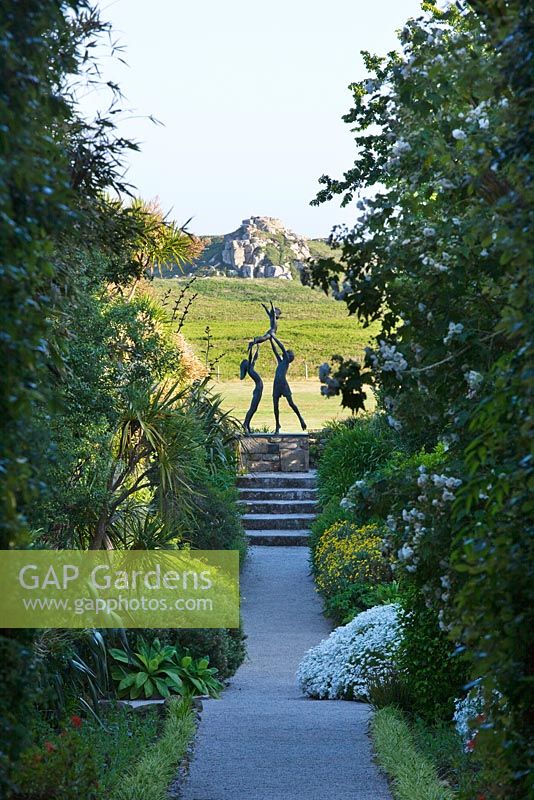 View down The Neptune Steps to sculpture - 'Tresco Children' by David Wynne. Tresco Abbey Garden, Tresco, Isles of Scilly. 