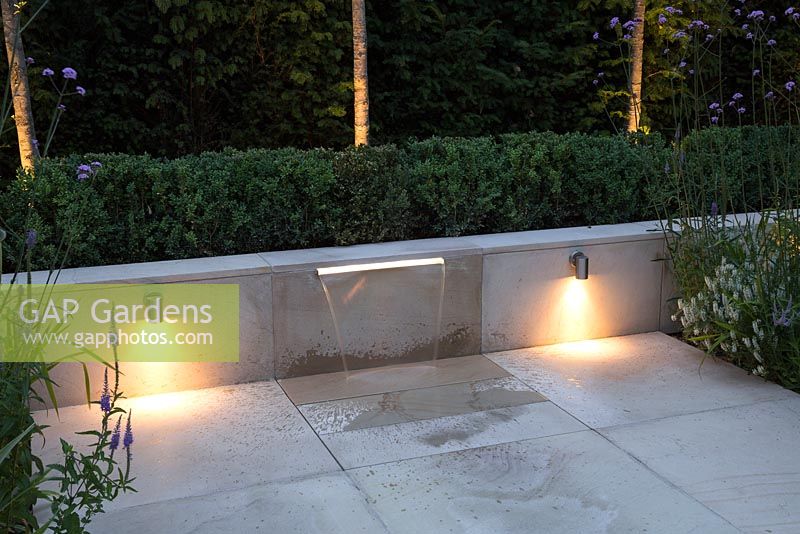 Downlight lighting on both sides of a water feature, with sunken borders either side