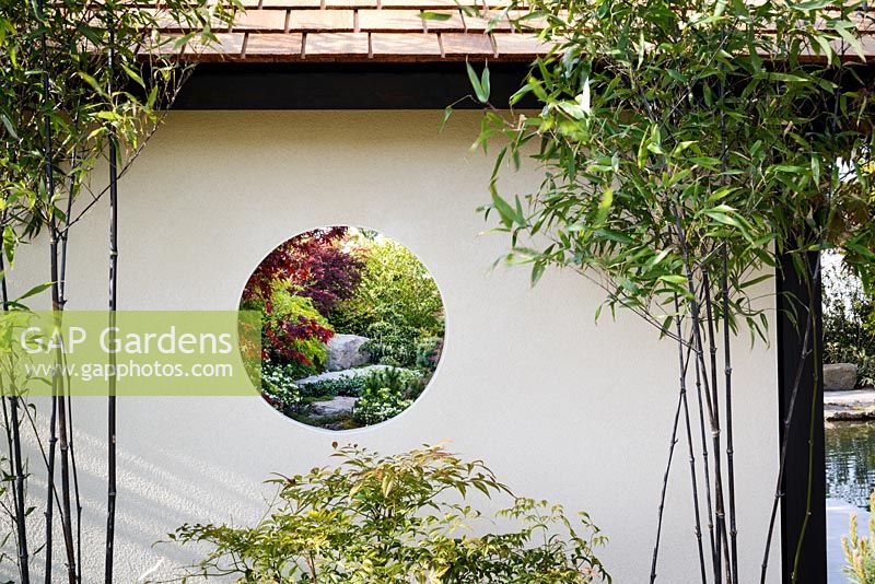 Circular view through garden pavilion, with Phyllostachys nigra and Nandina domestica - A Japanese Reflection, RHS Malvern Spring Festival 2016. Design: Peter Dowle and Richard Jasper, Howle Hill Nursery