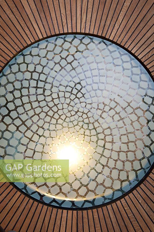 Detail of illuminated glass panels emulating the mathematically perfect Fibonacci spiral inset into the wooden floor of the belvedere in the Winton Beauty of Mathematics, Chelsea Flower Show 2016.