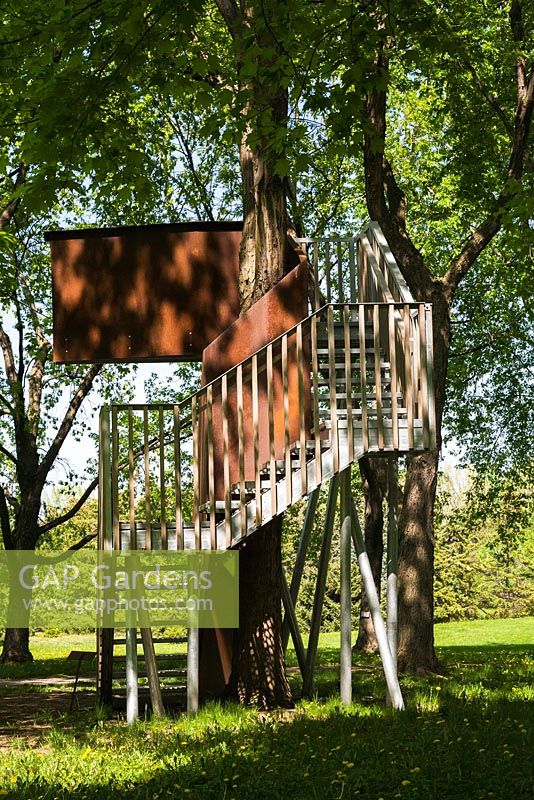 Elevated observation deck - treehouse built between two Acer - Maple trees in spring, Montreal Botanical Garden, Quebec, Canada