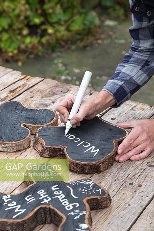 Use a white paint pen to write a label on the Oak slices