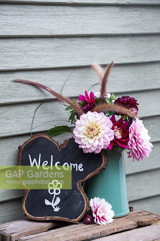 Oak tree slice painted and decorated to display 'Welcome' with Dahlia arrangement