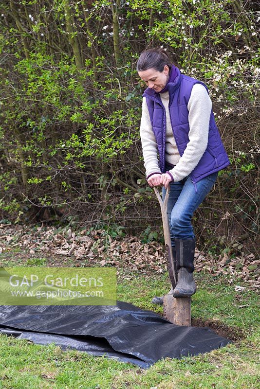 Use a spade to tuck and seal the weed control membrane into the ground