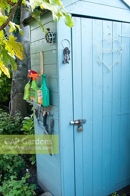 Blue painted shed with storage for tools 