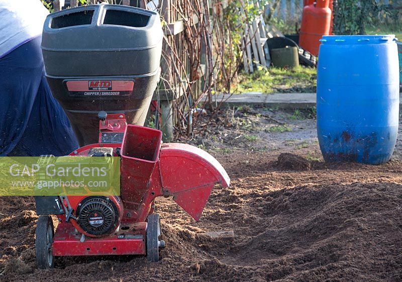 Petrol driven garden shredder being used to break up the content of used Gro Bags