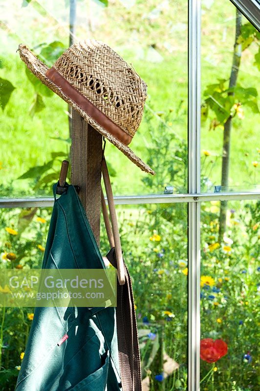 Wicker hat of gardener in a greenhouse