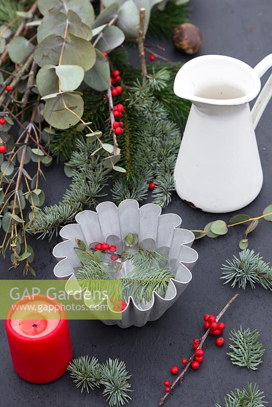 Materials required for constructing a frozen Pine candle bowl. Pine foliage, Eucalyptus and berries of Ilex verticillata