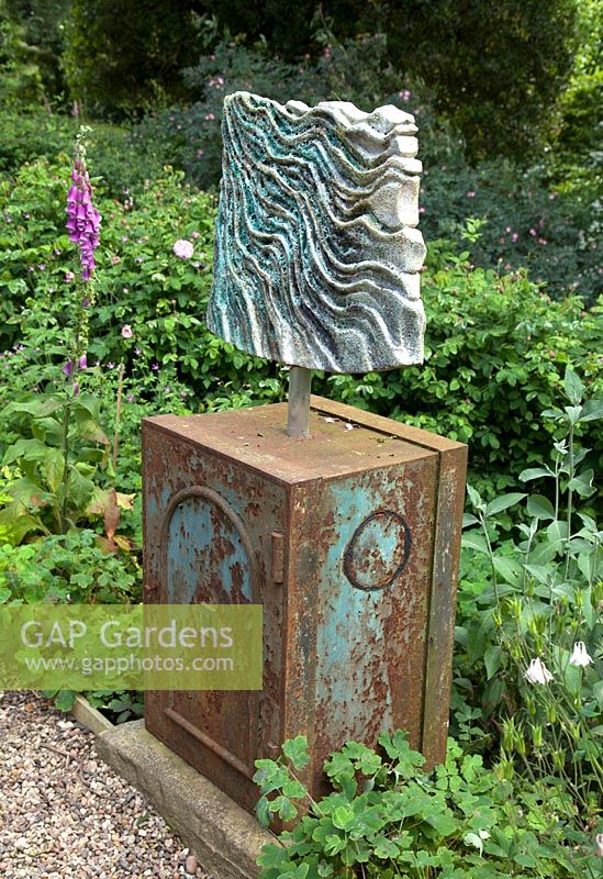 Sculpture by Wendy Lawrence in the terraced gardens at Bolham Manor, Nottinghamshire in June.
