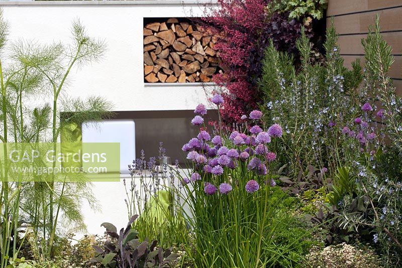 Herbs and woodstore in the Sociability garden at BBC Gardener's World Live 2015