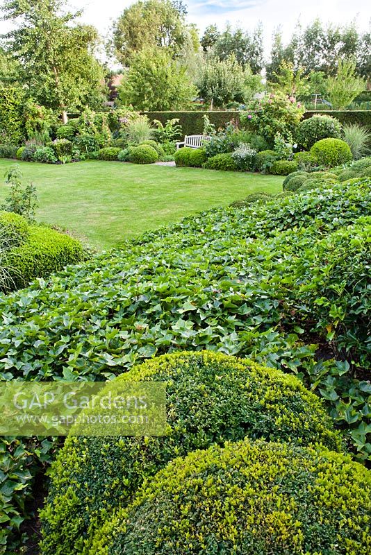 View of the garden sloping down to lawn and borders. Anneke Meinhardt garden