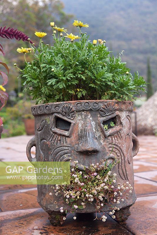 Terracotta pot with face design on tiled patio - Lake Atitlan Hotel, Guatemala