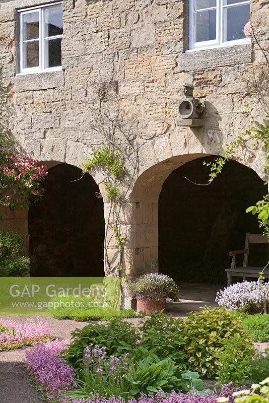 Archways in the old granary building in the Physic Garden - June, Herterton House, Hartington, Northumberland, UK 