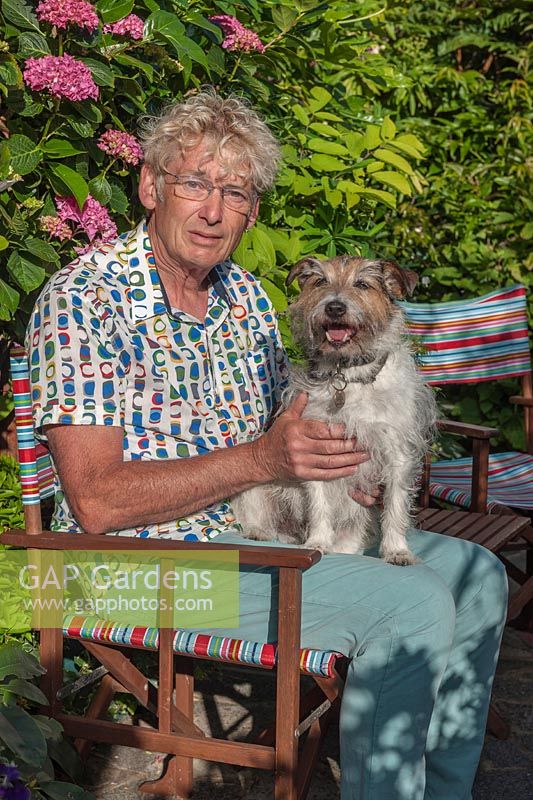 Portrait of Geoff Stonebanks of Driftwood garden and his terrier dog
