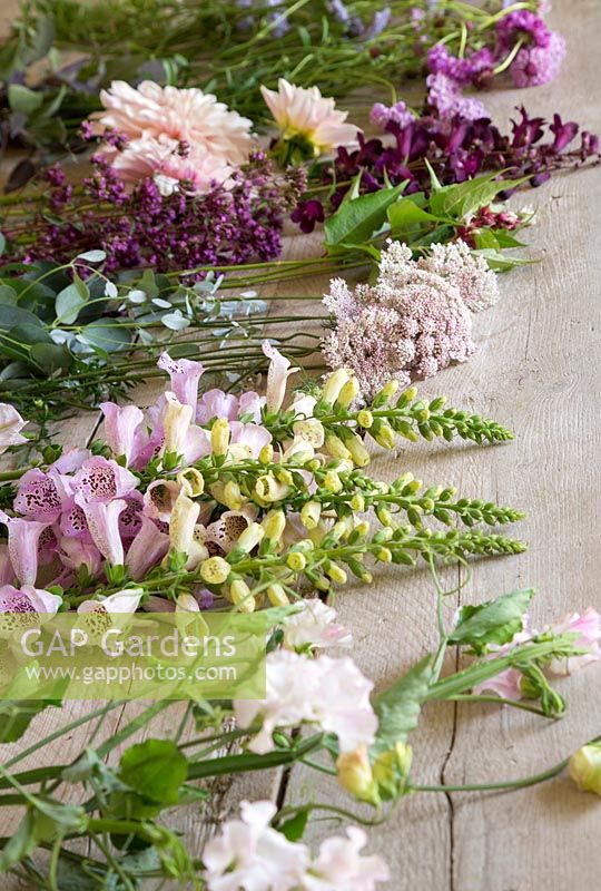 Cut flowers on wooden surface - ready for arranging