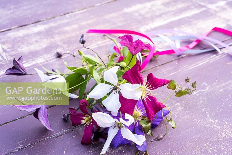 Clematis flowers tied into posy with ribbons