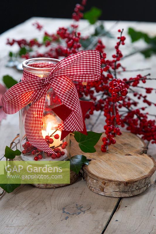 Decorated festive lantern with Berries and ribbon