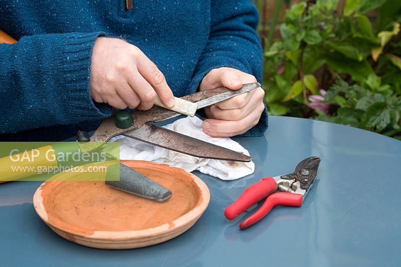 Gardener sharpening shears - Oxfordshire - August