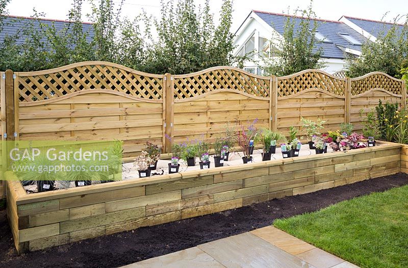Raised bed with plants labelled and placed on paper plan ready for the Garden on a Roll border