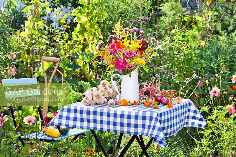 Floral and harvest display in the summer vegetable garden.