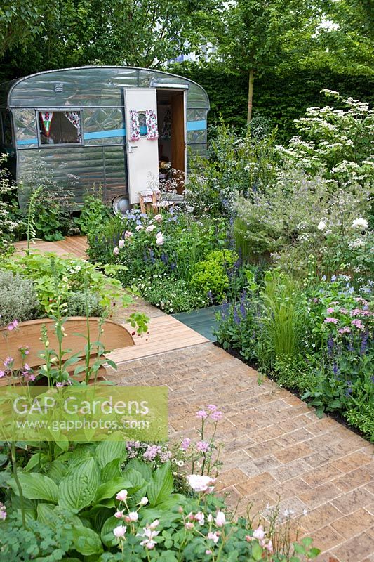 Brick paving and caravan with mixed herbaceous borders, A Celebration of Caravanning, RHS Chelsea 2012.