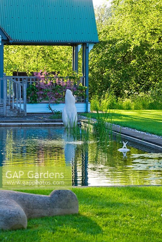 Summerhouse and pond with modern sculptures - Asthall Manor, Oxfordshire