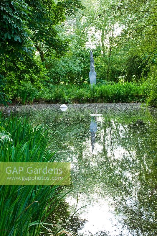 Pond with modern sculptures - Asthall Manor, Oxfordshire
