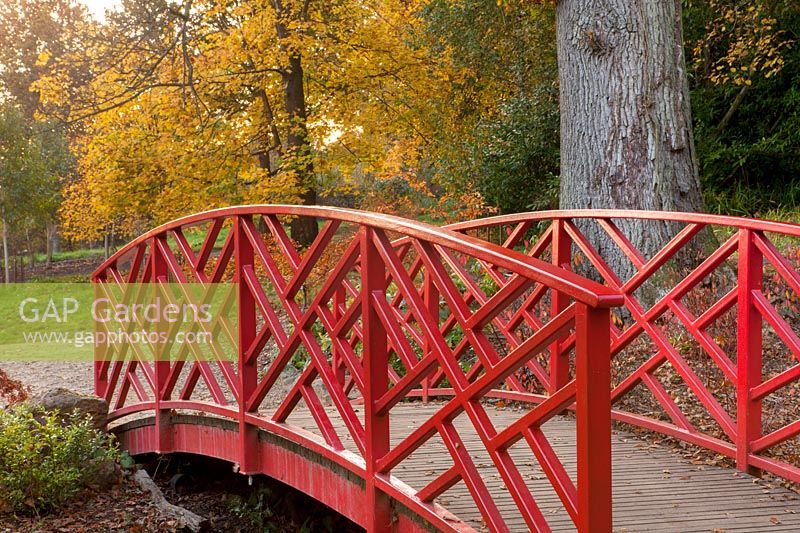A red Chinese bridge at Batsford Arboretum, Gloucestershire. 