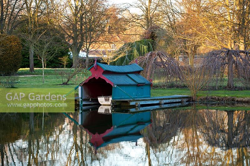 Boat house reflected in lake, Chippenham Park, Cambridgeshire.