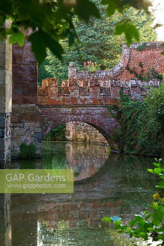 View of stone and brick bridge over the moat in summer
