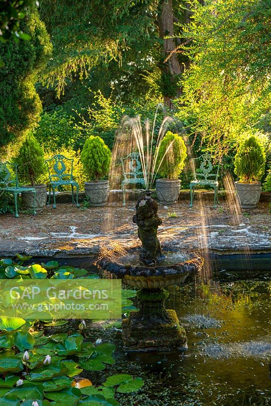 Lily pond with cherub fountain sculpture
