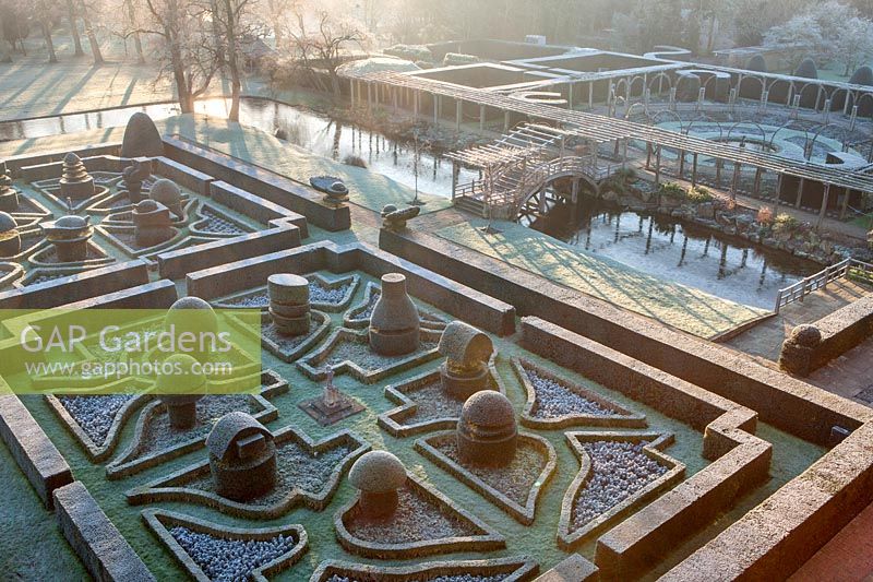 Elevated view of the formal topiary garden in winter with bridge leading to other formal gardens