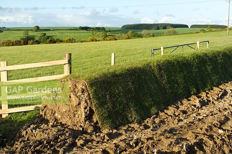 Turf wall being built alongside fields