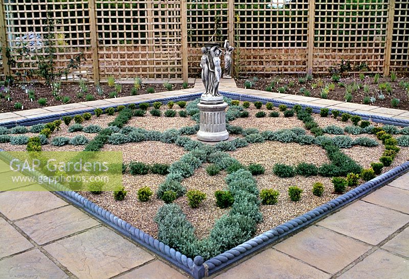 Newly built planted small herb garden with knot design of herb varieties