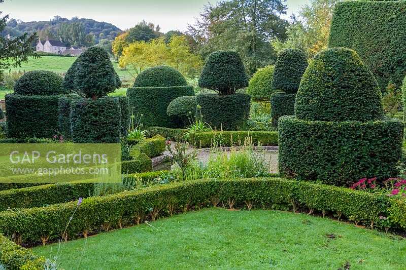 Owlpen Manor, Gloucestershire, UK. Autumn, view across the topiary garden