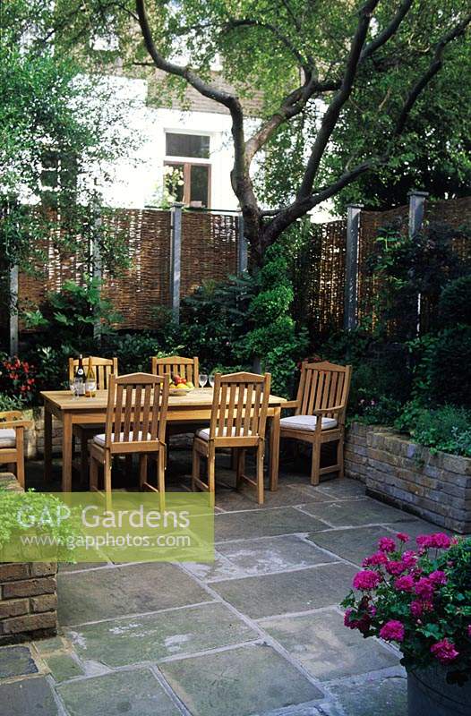 small patio garden London Design Steven Woodham Table york stone paving Fence