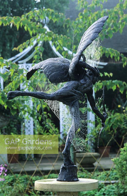 RHS Wisley Surrey spiders' webs on Eros sculpture in patio garden design by Julie Toll.