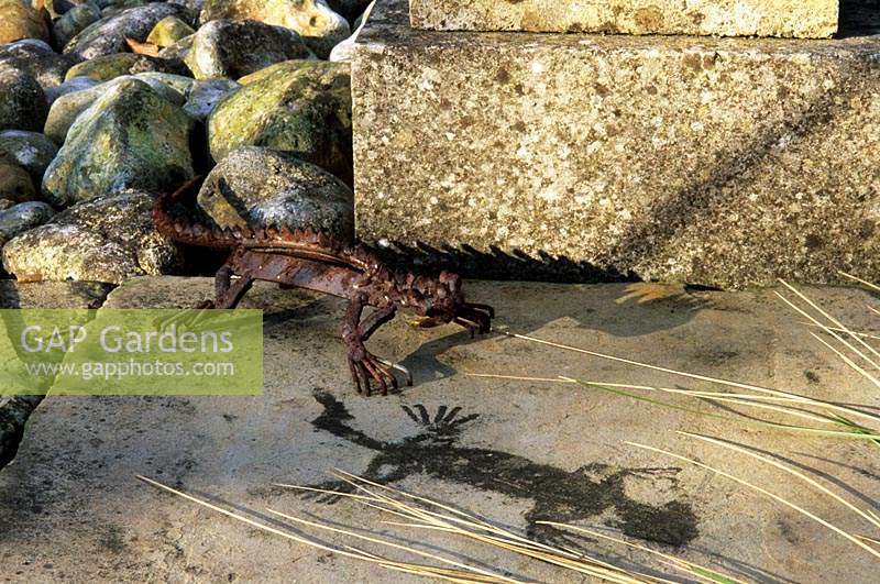 Mitchmere Farm Sussex metal lizard sculpture with shadow and fossil