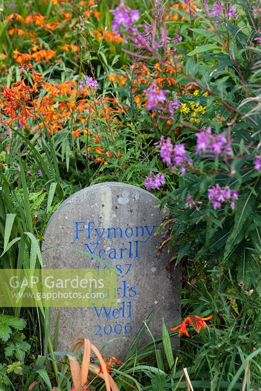 View of memorial stone to local place names, surrounded by a flowering Wild Garden. 