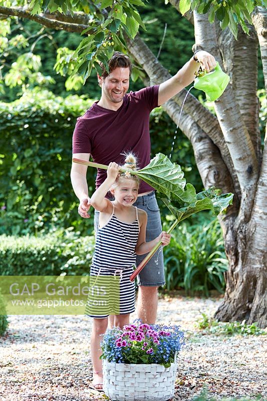 Father and daughter having fun in the garden