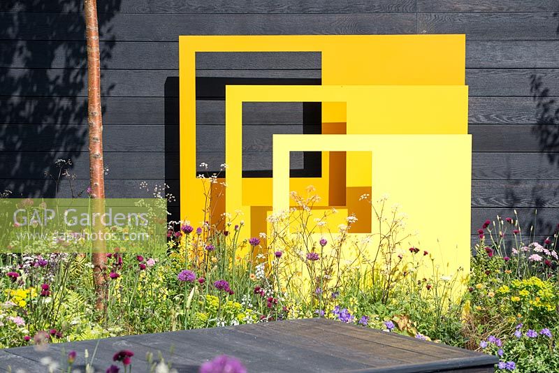 Yellow steel sculptural panels with black fence background - 'Urban Oasis', RHS Malvern Spring Festival 2018. 