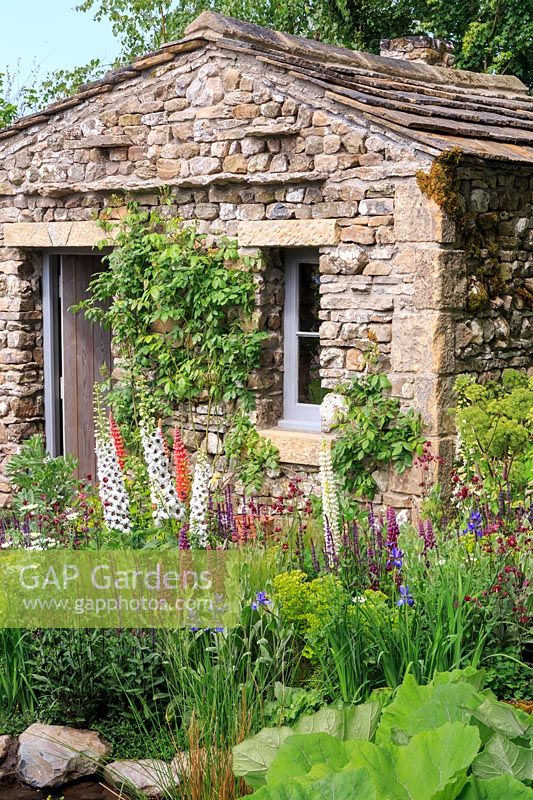 Stone cottage in show garden. Welcome to Yorkshire garden, Sponsor: Welcome to Yorkshire, RHS Chelsea Flower Show, 2018.