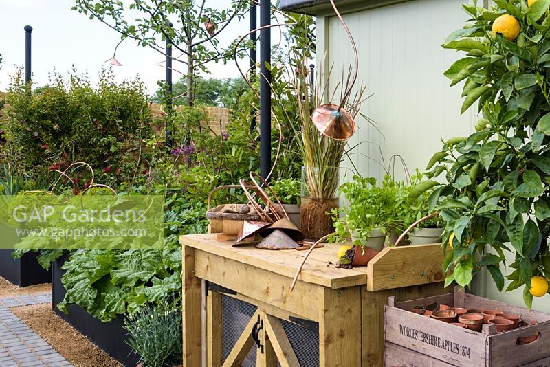 Potting bench with herbs and garden trug - 'The Perfumer's Garden', RHS Malvern Spring Festival, 2018. Sponsor: Keyscape Design. 