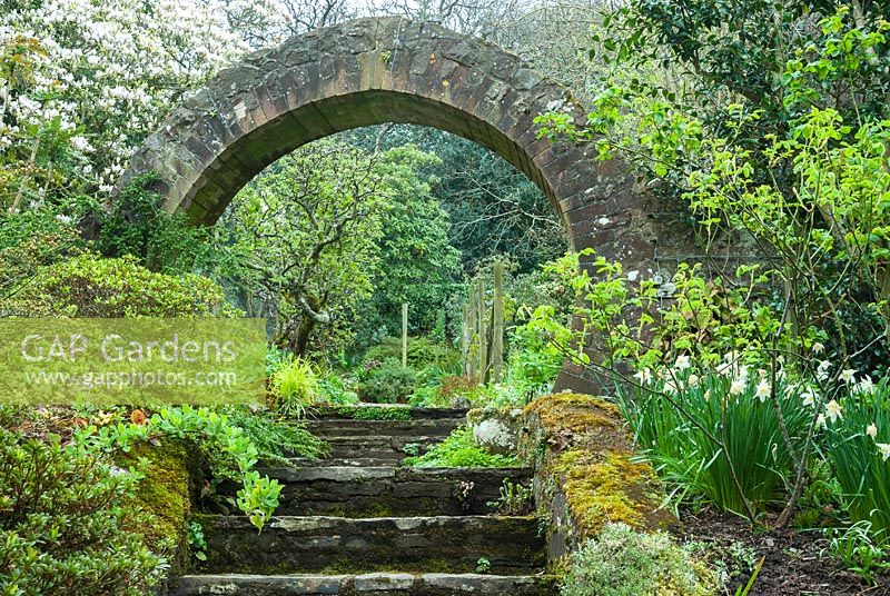 View up steps to circular brick-built entrance and garden beyond. Greencombe Garden, Porlock, Somerset, UK. 