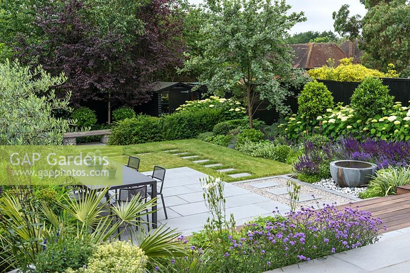 Dining patio and water bowl with border of hydrangea, bay standards and whitebeam