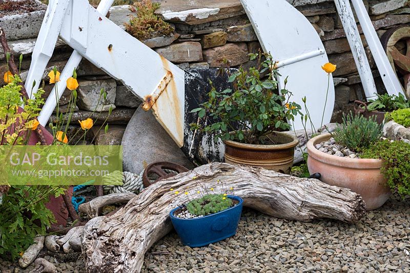Decommissioned rudders and driftwood add to a seaside feel.