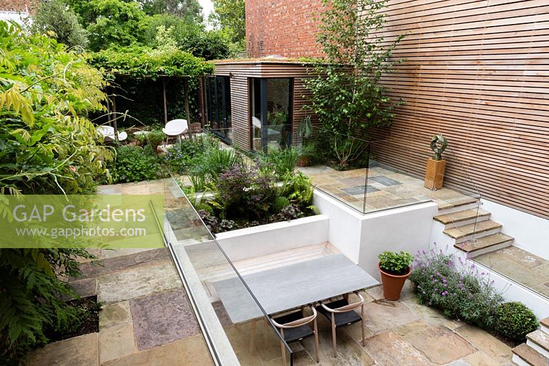View of sunken seating area in multi-level contemporary garden.