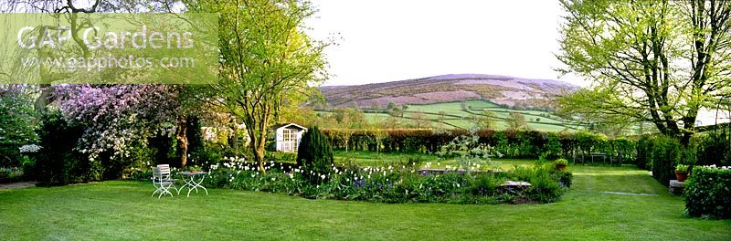 The spring flowering White Border by the Main Lawn at Summerdale Garden, Cumbria, UK. 