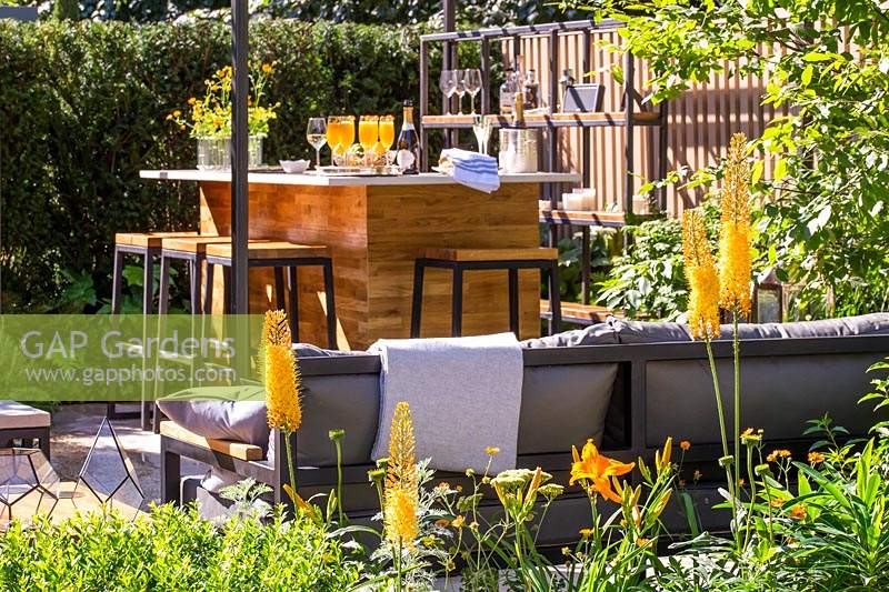 View to drinks bar and seating area with Eremurus - Foxtail Lily - 
in the foreground in 'The Landform Garden'
